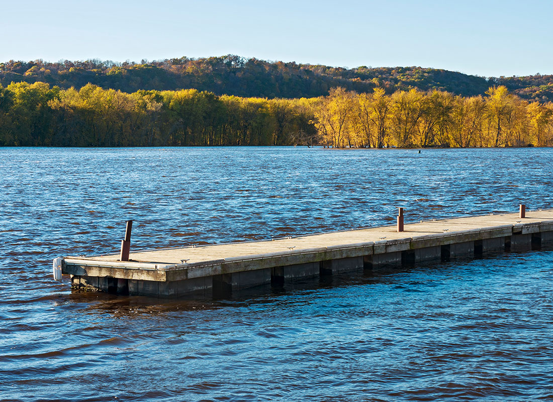 Prairie du Chien, WI - View of an Empty Boat Dock on the Lake Surrounded by Trees on a Sunny Day in Prairie du Chien Wisconsin
